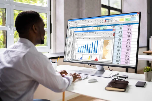 Analyst Employee Working With Spreadsheet On Computer