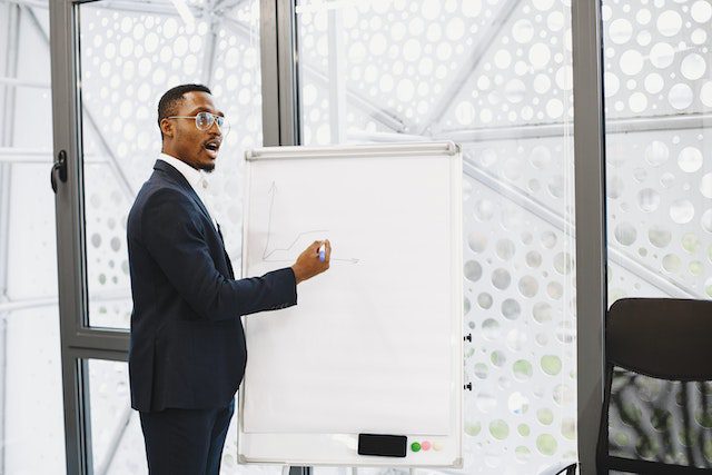 businessman-presenting-on-a-flipchart-in-an-office