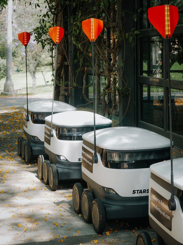 delivery-robots-parked-beside-glass-wall
