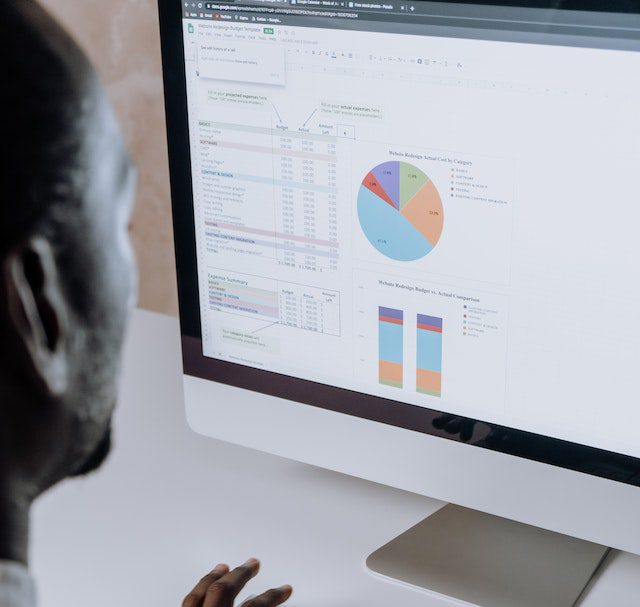 Some one looking at a loan schedule on a computer screen 