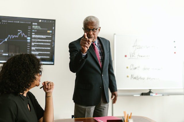 man-pointing-finger-while-discussing-with-his-colleague