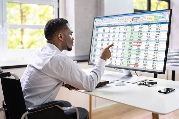 Man Using Finance Spreadsheet Report On Laptop Screen
