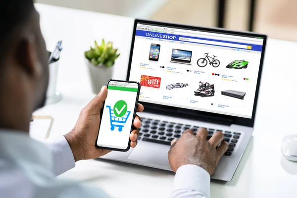 Close-up Of A Businessperson's Hand Doing Online Shopping On Smartphone