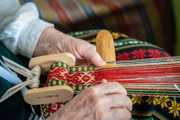 woman working with traditional weaving loom